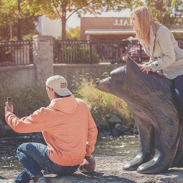 Students interacting with bear sculptures